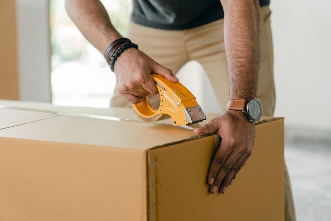 Couple transportant des cartons lors d'un déménagement