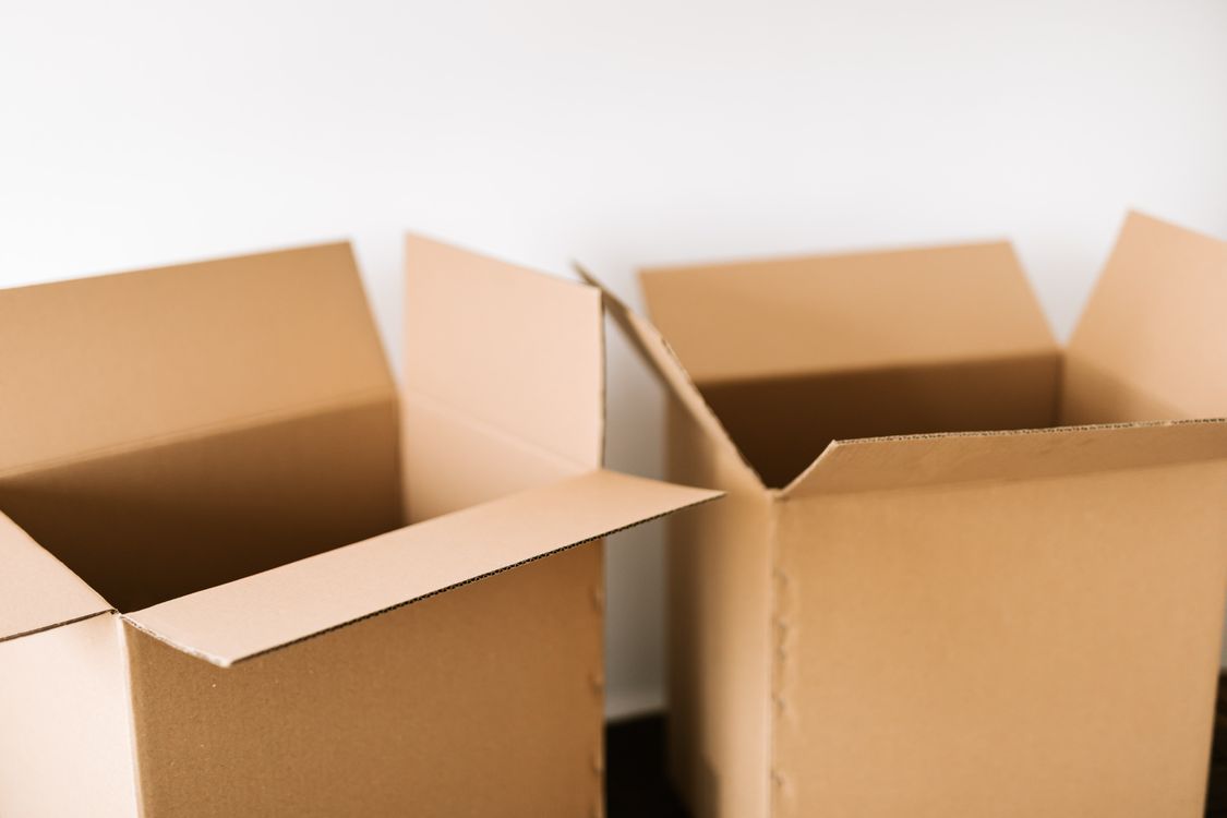 Personne emballant des affaires dans un carton de déménagement