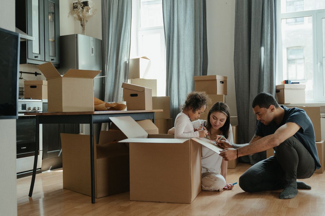Famille déballant des cartons après un déménagement dans leur nouveau logement